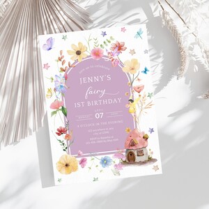 May include: A purple and white invitation card with a fairy and a mushroom house. The text on the card reads "Join us to celebrate Jenny's fairy 1st birthday, Monday, July 07, 4 o'clock in the evening, 121 anywhere st, any 12345, RSVP to Natasha at 123-456-7010 by May 10th."