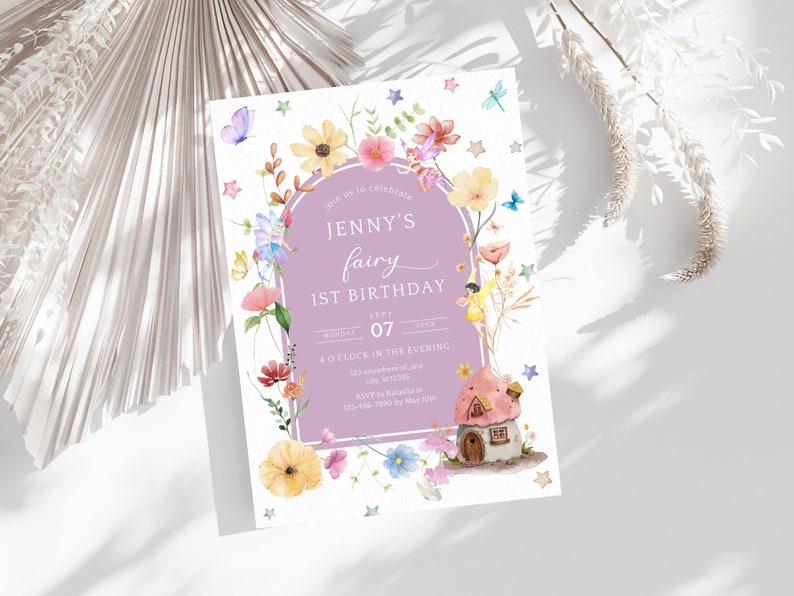 May include: A purple and white invitation card with a fairy and a mushroom house. The text on the card reads "Join us to celebrate Jenny's fairy 1st birthday, Monday, July 07, 4 o'clock in the evening, 121 anywhere st, any 12345, RSVP to Natasha at 123-456-7010 by May 10th."