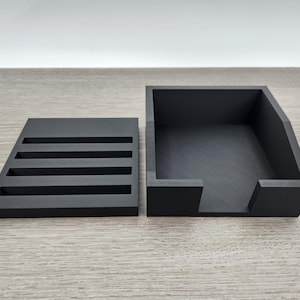 May include: A black, rectangular storage box with a removable tray. The tray has five slots for organizing small items.