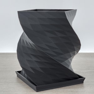 May include: A black, 3D printed planter with a unique, twisted design. The planter has a square base and a wide, open top.