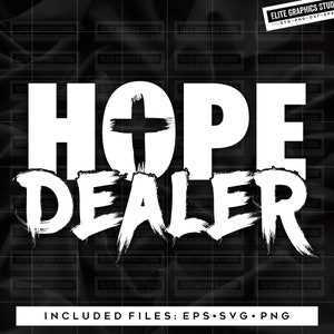 May include: White text on a black background reads "HOPE DEALER" with a cross symbol between the words. The text has a distressed, brushstroke effect.