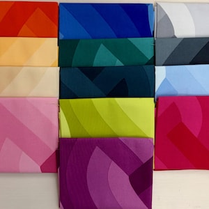May include: A collection of folded fabric pieces in various colors, including red, orange, blue, green, pink, and purple. Each piece features a geometric, curved design with color gradients. The fabrics are neatly arranged, showcasing a range of hues.
