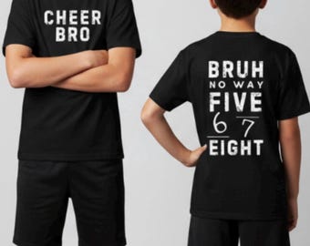 May include: Two children wearing matching black t-shirts and shorts. One shirt says "CHEER BRO" in white block letters. The other shirt says "BRUH NO WAY FIVE 6 7 EIGHT" in white block letters.