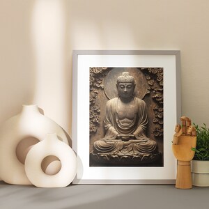 May include: A framed print of a brown Buddha statue sitting in a meditative pose. The statue is surrounded by a carved floral design. The print is displayed on a shelf with two white ceramic vases and a wooden hand sculpture.