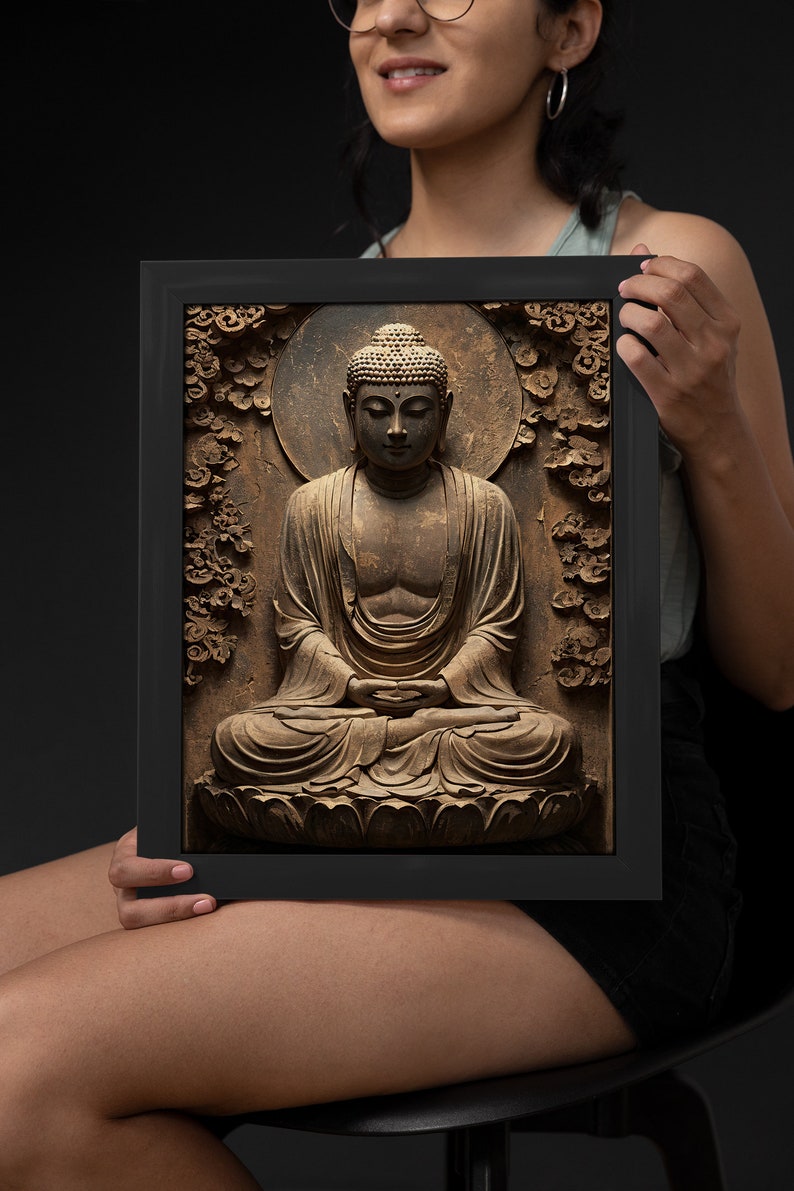 May include: A framed print of a brown wooden sculpture of Buddha sitting in meditation. The sculpture is surrounded by carved floral details and a halo. The print is in a black frame.