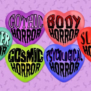 May include: Six heart-shaped sweets in different colours, each with a horror subgenre written on it: Monster, Gothic, Body, Cosmic, Psychological, and Slasher Horror. The background is a light purple with a repeating squiggly pattern.