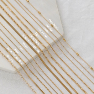 May include: A collection of gold-colored necklaces with various chain styles, including rope, snake, and box chains. The image displays several necklace designs, each with a unique texture and pattern. Text labels identify each style, such as "Duo Beads" and "Hearts."