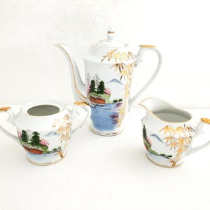 Small Kutani Japanese Porcelain Teapot / Coffee Pot with Creamer and Sugar Bowl, Gold Detail, Lakeside Village Scene and Bamboo Stalks