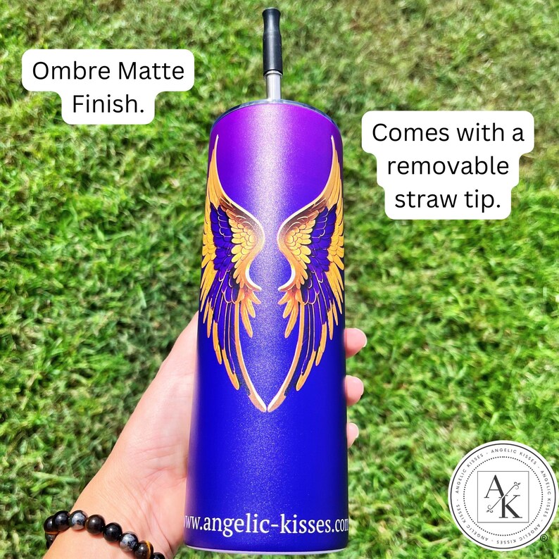 May include: A purple and blue ombre tumbler with a gold angel wing design. The tumbler has a matte finish and includes a removable straw tip. The website address www.angelic-kisses.com is printed on the tumbler.