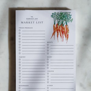 May include: A white Market List notepad with the text "HARVEST JOY" and "MARKET LIST". The notepad has sections for fresh produce, meats, dairy, and other items. A watercolor illustration of carrots with green tops is in the upper right corner.