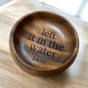 May include: A wooden bowl with the text "left it in the water 2.4.24" engraved on the inside.