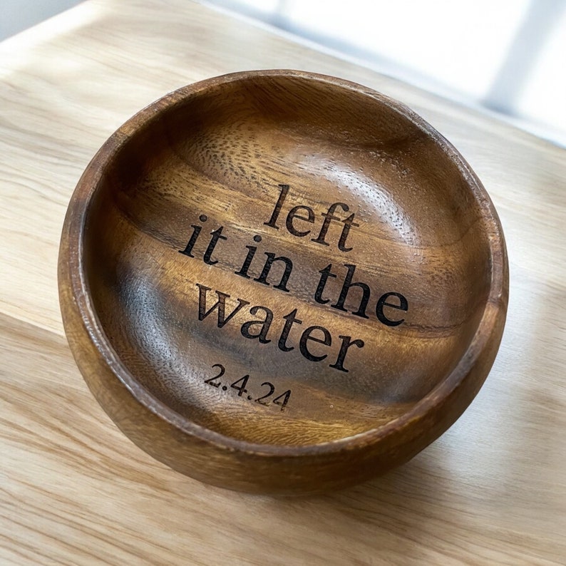 May include: A wooden bowl with the text "left it in the water 2.4.24" engraved on the inside.