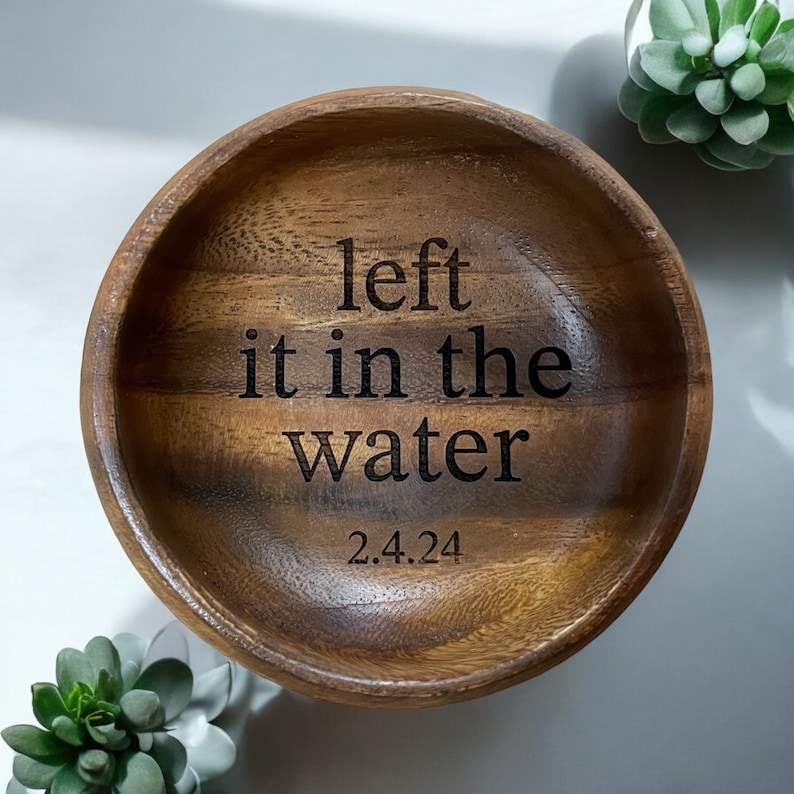May include: A wooden bowl with the text "left it in the water 2.4.24" engraved on the inside.
