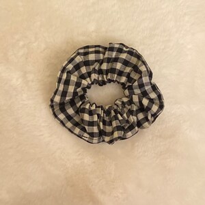 May include: Black and white gingham scrunchie hair tie.
