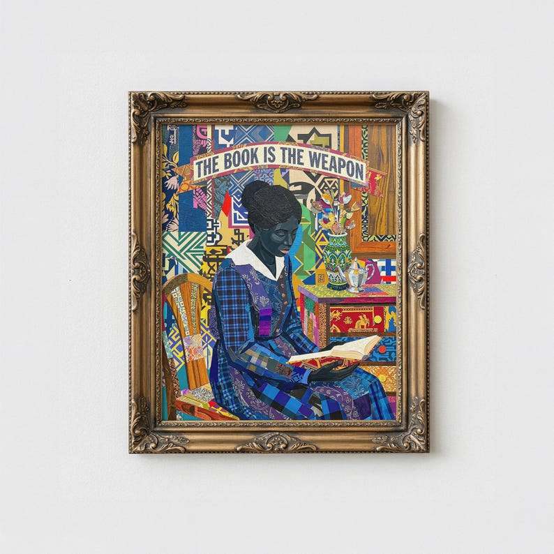 May include: Framed artwork featuring a woman reading a book, with the text "THE BOOK IS THE WEAPON" above her. She is wearing a blue plaid dress and seated in a wooden chair. The background is a colorful patchwork of patterns, with a gold ornate frame.