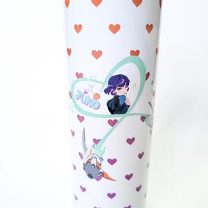 May include: White stainless steel tumbler with a pink and purple anime character design. The design features a heart with the word "JINO" inside. The background is covered in a pattern of small pink hearts.