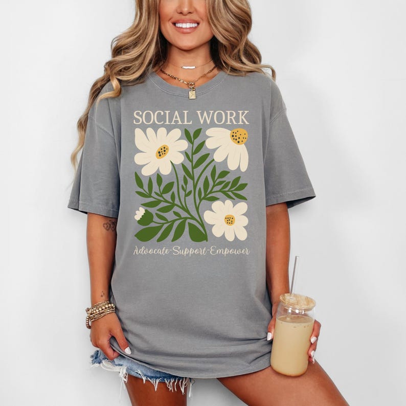 May include: Gray t-shirt with a floral design and the text "SOCIAL WORK Advocate-Support-Empower".