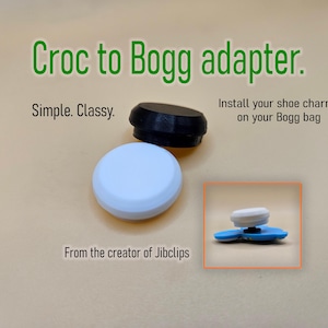 May include: A black and white circular adapter for shoe charms, featuring the text Croc to Bogg adapter, Simple. Classy., Install your shoe charms on your Bogg bag, and From the creator of Jibclips. The image shows the adapter components.