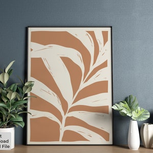 May include: A digital print of a stylized leaf in shades of brown and white. The leaf is set against a brown background and is framed in a black frame.