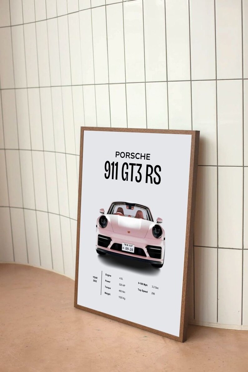 May include: A framed poster with a white background featuring a pink Porsche 911 GT3 RS. The poster includes the car's specifications, including the year, engine size, power, torque, 0-100 mph time, and top speed.
