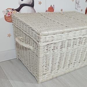 May include: White wicker storage basket with a lid. The basket is woven with a tight, even pattern and has a natural, rustic look.