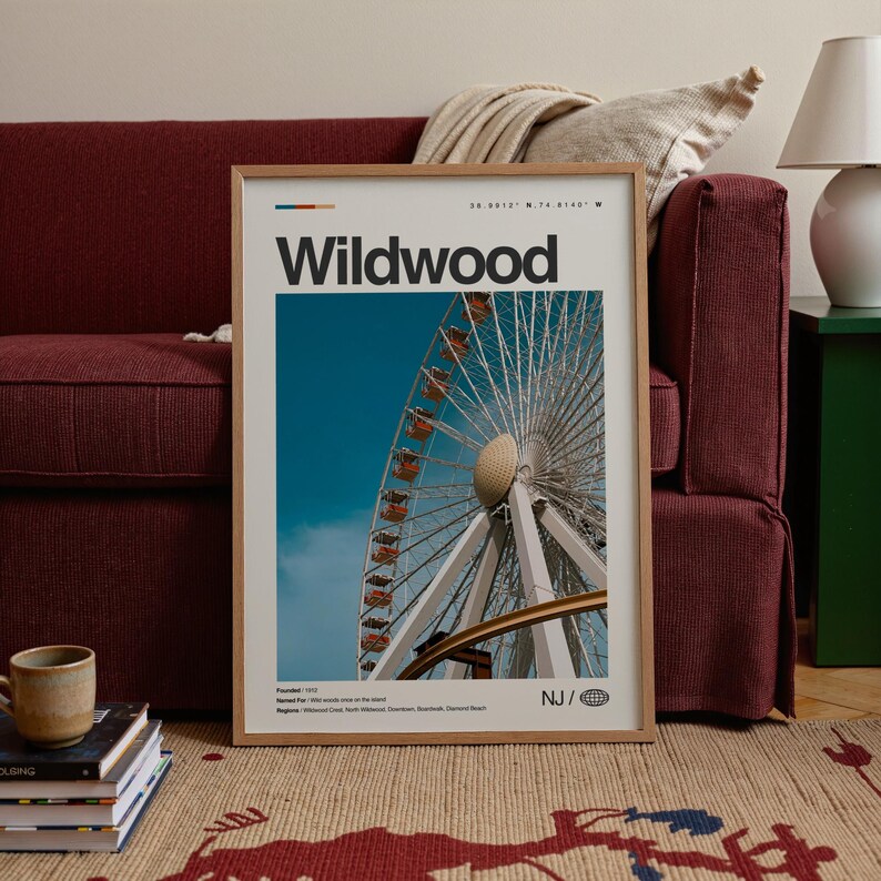May include: A framed poster featuring the word "Wildwood" in bold black letters. The poster showcases a Ferris wheel against a blue sky. The poster is in a wooden frame and is displayed on a patterned rug.