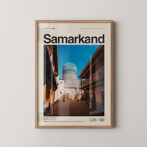 May include: Framed print featuring a photograph of Samarkand, Uzbekistan, with the city name in large black letters. The image shows a blue-domed building and surrounding architecture under a clear blue sky. The frame is light brown.