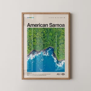 May include: A framed poster featuring an aerial view of American Samoa. The image shows a vibrant green forest meeting the blue ocean, with white waves crashing on the shore. The text "American Samoa" is prominently displayed, along with coordinates and other details.