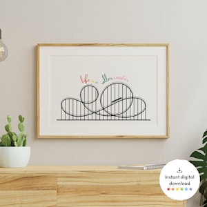 Può includere: Un download digitale stampabile di un'illustrazione in bianco e nero di una montagna russa con il testo "life is a roller coaster" in lettere colorate.