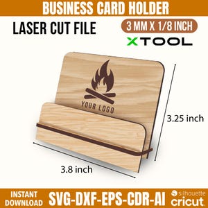 K&ouml;nnte beinhalten: Ein Visitenkartenhalter aus Holz mit Laser-Cut-Design. Der Halter zeigt ein Lagerfeuer-Logo und den Text "YOUR LOGO". Er ist 9,65 cm breit und 8,26 cm hoch. Das Design ist 3 mm x 3,18 mm. Der Text "LASER CUT FILE" ist ebenfalls enthalten.