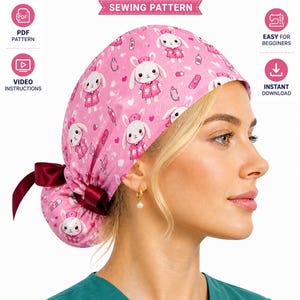 May include: A pink ponytail scrub cap with a repeating pattern of cartoon bunnies in nurse outfits. The cap has a burgundy bow and is labeled "Sewing Pattern". The image also includes text that says "PDF Pattern", "Video Instructions", "Easy for Beginners", and "Instant Download".