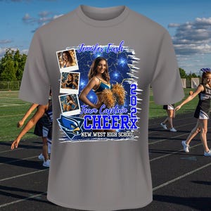 May include: Gray t-shirt with a blue and white graphic design featuring a cheerleader with pom-poms and the text "Jennifer Eash Team Captain 2022 Cheer New West High School".