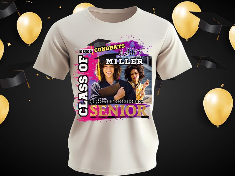 May include: White t-shirt with a pink, purple, and gold design. The design includes the text "Class of 2025 Congrats Ashley Miller Hamilton High School Senior". A photo of two people in graduation gowns is in the center of the design.
