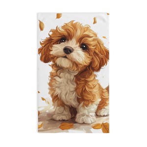 May include: A cute, fluffy brown and white puppy with a sweet expression, sitting on a white background with scattered brown leaves.