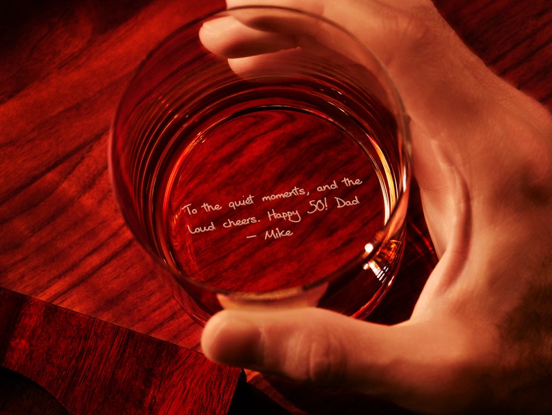 May include: A clear glass with a handwritten message inside: "To the quiet moments, and the loud cheers. Happy 50! Dad - Mike"