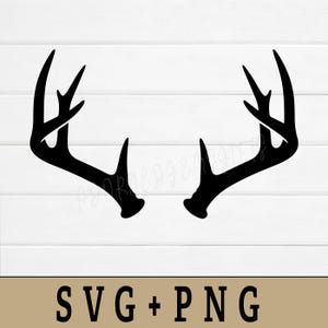 May include: Black silhouette of a pair of deer antlers against a white, wood-paneled background. The antlers are symmetrical and detailed, with multiple points. The bottom of the image has the text "SVG + PNG".