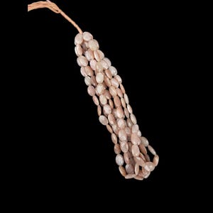 May include: A strand of oval-shaped sunstone beads in a pale peach colour. The beads are strung on a brown cord.