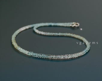 May include: A delicate necklace composed of small, faceted beads in shades of pale blue, green, and pink. The necklace is strung together with a silver clasp. The text "vgagems" is visible in the lower right corner.