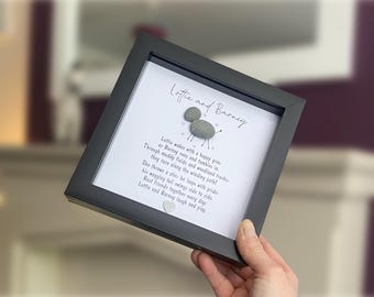 May include: A square black frame containing a white background with the text Lottie and Barney, a poem, and a pebble art dog figure. The dog is made of two grey stones with hand-drawn legs and a tail, surrounded by small drawn hearts and a small heart.