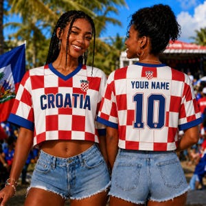 Two women wearing red and white Croatia soccer jerseys with the name "Cratia" and the number 10 on the back, smiling and posing together.