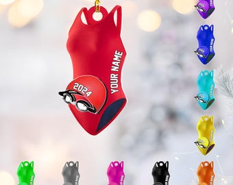 May include: Red swimsuit ornament with the text "YOUR NAME" and a red swim cap with "2024" and goggles. Additional ornaments in various colors are also shown.