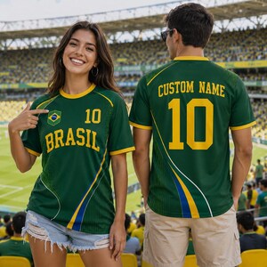 A woman wearing a green and yellow soccer jersey with the number 10 and the word "Brasil" on it, posing in a stadium with a man wearing a matching jersey with the number 10 and the word "Custom Name" on it.