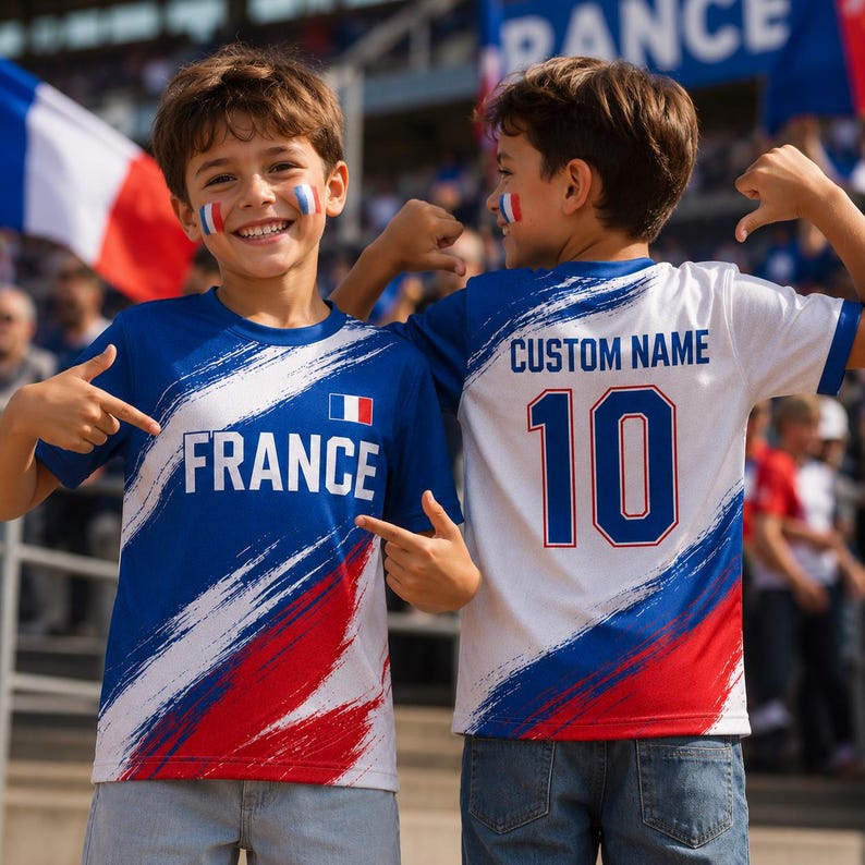Two young boys wearing France-themed soccer jerseys with the custom name "Custom Name" and the number 10, smiling and pointing at the camera.