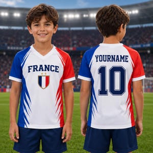 A young boy wearing a red, white, and blue soccer jersey with the word "FRANCE" and the number 10 on the back.