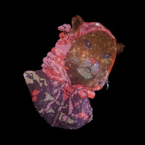 May include: A sparkling, jewel-encrusted cat head design with a pink head covering and a patterned purple and pink garment. The cat's face is detailed with blue eyes and a smiling mouth, all set against a black background.