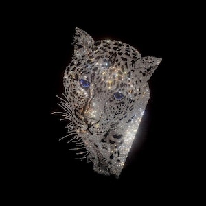 May include: A close-up of a white leopard's face made entirely of sparkling rhinestones. The leopard's blue eyes are visible, and the rhinestones create a shimmering effect.