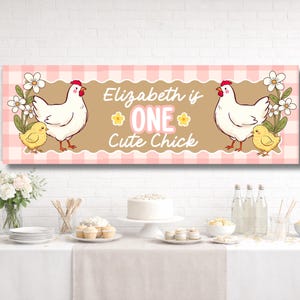 May include: A banner with a pink and white checkered background features illustrations of a white hen and a yellow chick. The text "Elizabeth is ONE Cute Chick" is displayed in the center, with floral accents. The banner is designed for a birthday celebration.