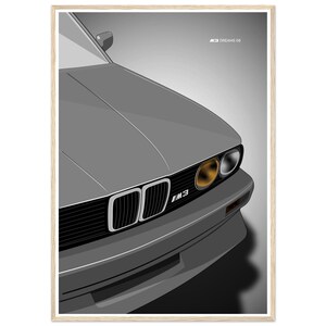 May include: A framed digital illustration of a grey BMW M3 car front end, featuring the iconic dual kidney grille, rectangular headlights with one amber lens, and the M3 emblem. The text M3 DREAMS 06 is printed in the upper right corner.