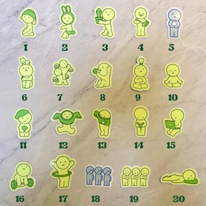 May include: Twenty green and yellow stickers featuring a cartoon character with different expressions and activities. The stickers are numbered 1 through 20.