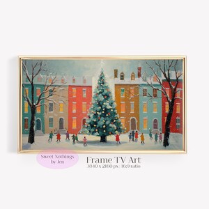 May include: A framed print of a winter scene with a decorated Christmas tree in front of colorful buildings. People are walking in the snow. The print has a gold frame and the text "Frame TV Art".